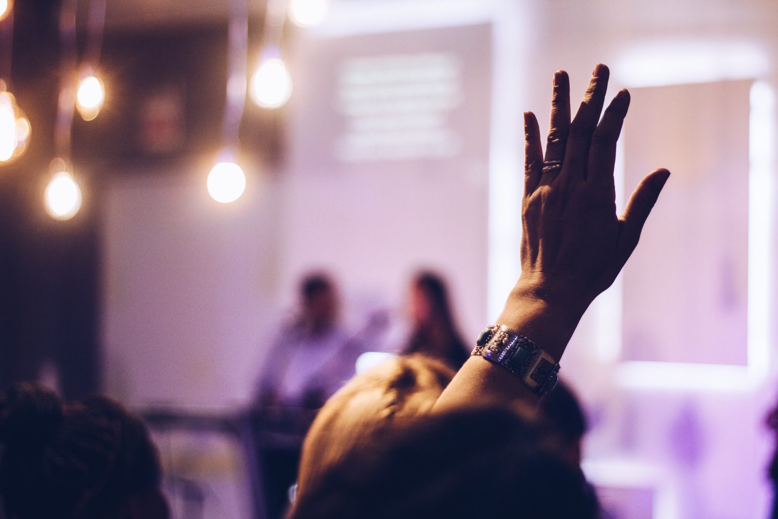 Trade show participant raising their hand