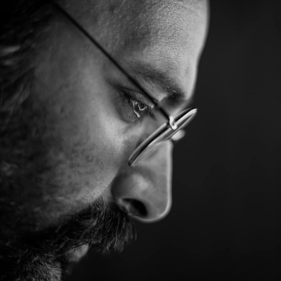 img-2 A mean with glasses glancing down