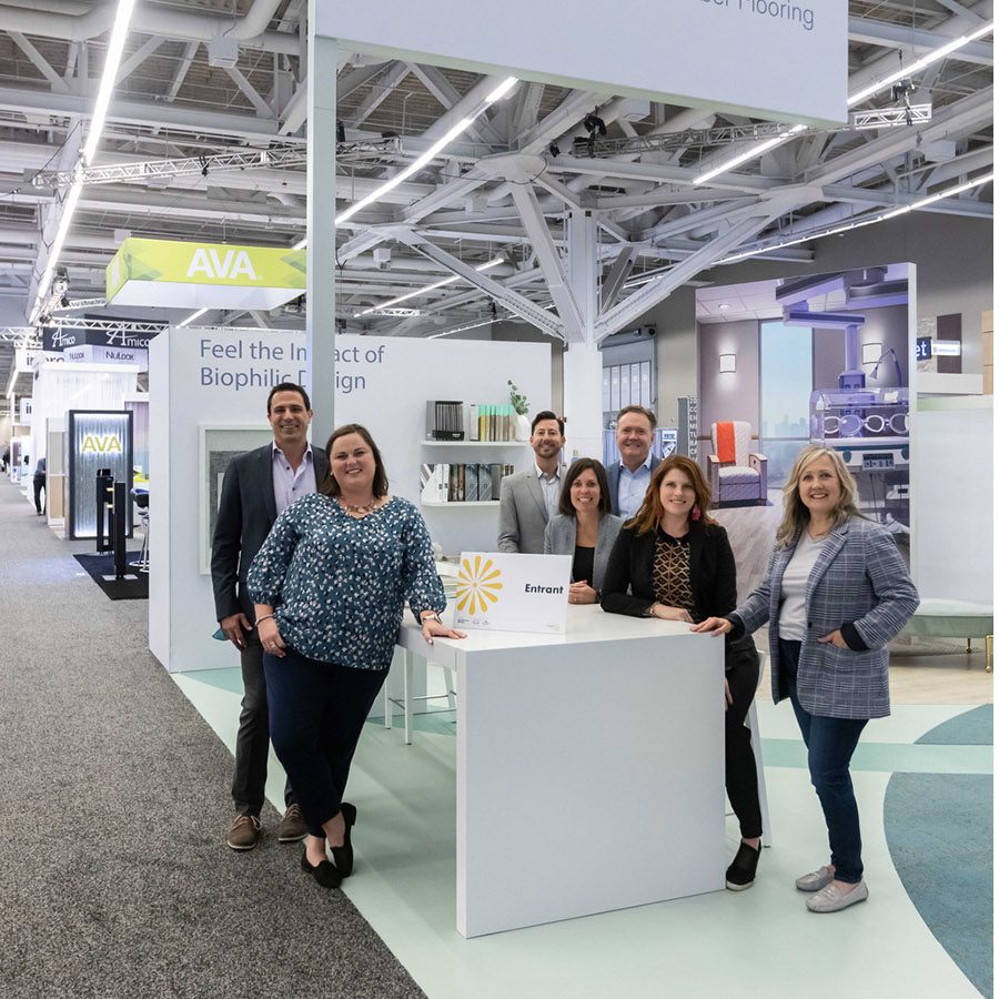 900x900 The Interface team standing in their trade show booth
