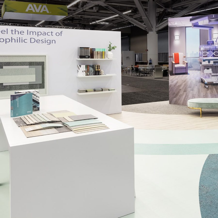 900x900 A part of the Interface trade show booth, showing a table with fabric samples