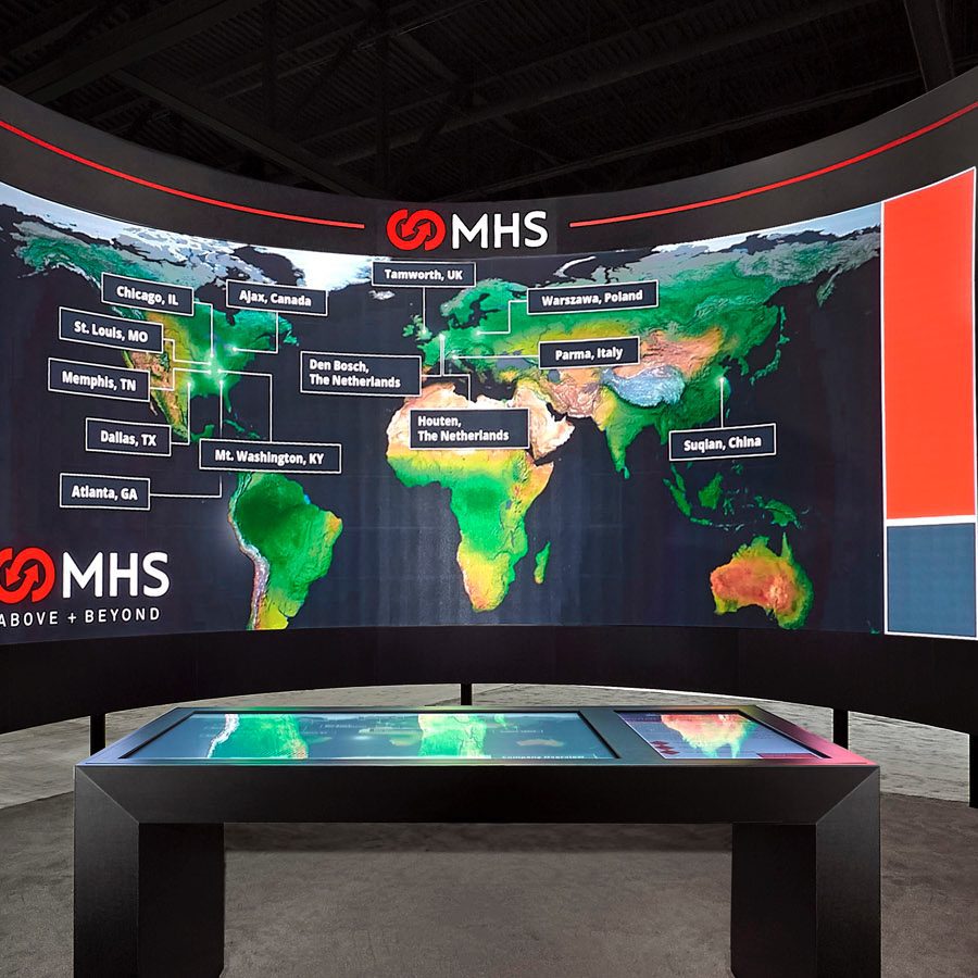 MHS trade show booth with a large world map