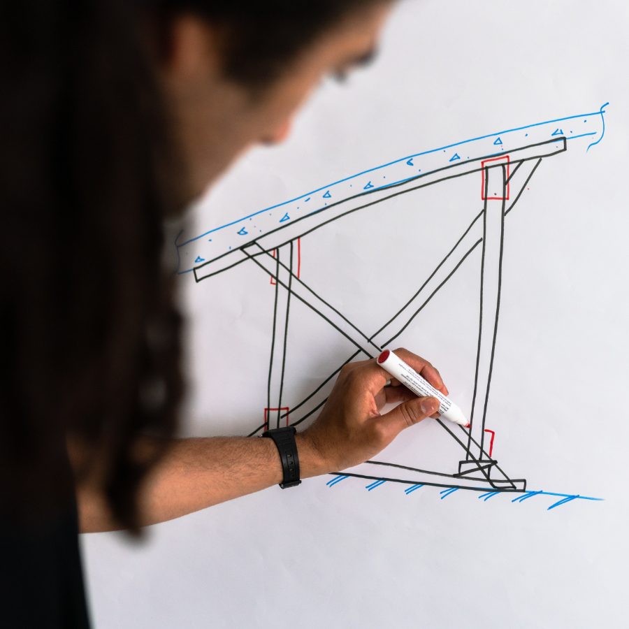 img-2 A person drawing a schematic on a whiteboard